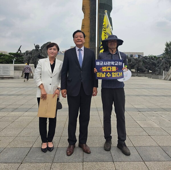 지난 27일 더불어민주당 황기철 진해구지역위원장(가운데)과 김묘정 진해구 사무국장이 국방부장관 및 정부 관계자들을 잇따라 만난 뒤 서울 용산 전쟁기념관을 찾아 해군사관학교 진해존치를 위해 시위학고 있는 시민과 포즈를 취하고 있다. /김묘정 진해구지역위원회 사무국장 페이스북 갈무리