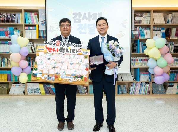 김성환 한국투자증권 사장(오른쪽)이 지난 1일 용인 선한사마리아원에서 열린 '꿈 도서관' 개관식에서 송한철 원장 및 원아들이 건넨 감사패를 들고 기념사진을 촬영하고 있다. /한국투자증권